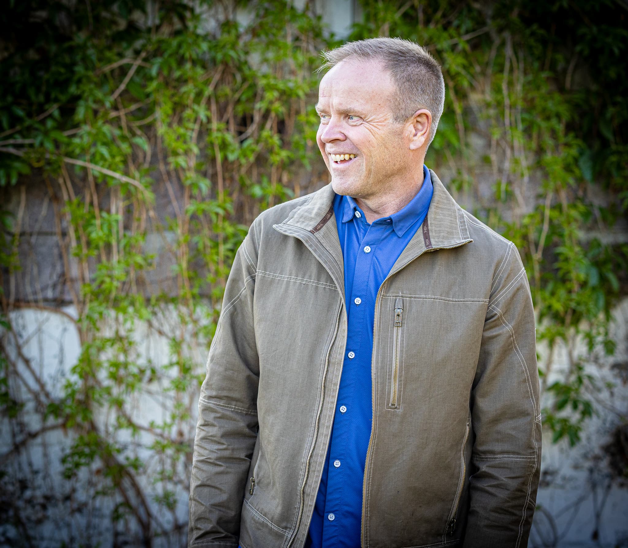 Dale Dixon smiling outdoors in a blue shirt and jacket